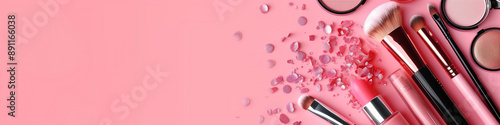 Makeup and cosmetics products set on pastel background with a copy space banner