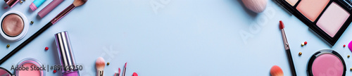 Makeup and cosmetics products set on pastel background with a copy space banner
