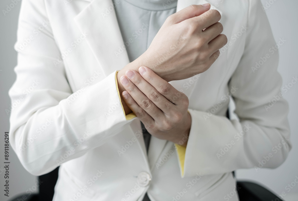 Woman hand with wrist pain numbness and pain in the palm of the hand has pain and tingling in the nerve endings This is a side effect of sitting and working for a long time on a laptop at the office Woman hand with wrist pain numbness and pain in the palm of the hand has pain and tingling in the nerve endings This is a side effect of sitting and working for a long time on a laptop at the office