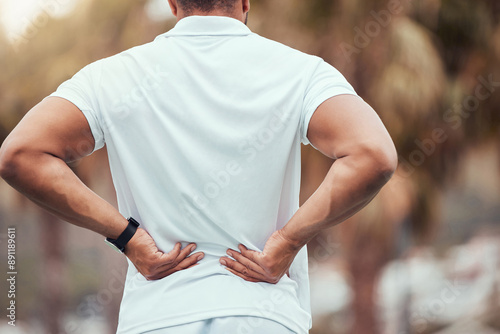 Backache, tennis and person with pain, outdoor and suffering in court for competition, player and sports. Injury, uniform and man with strain of muscle, rubbing and athlete with massage in field