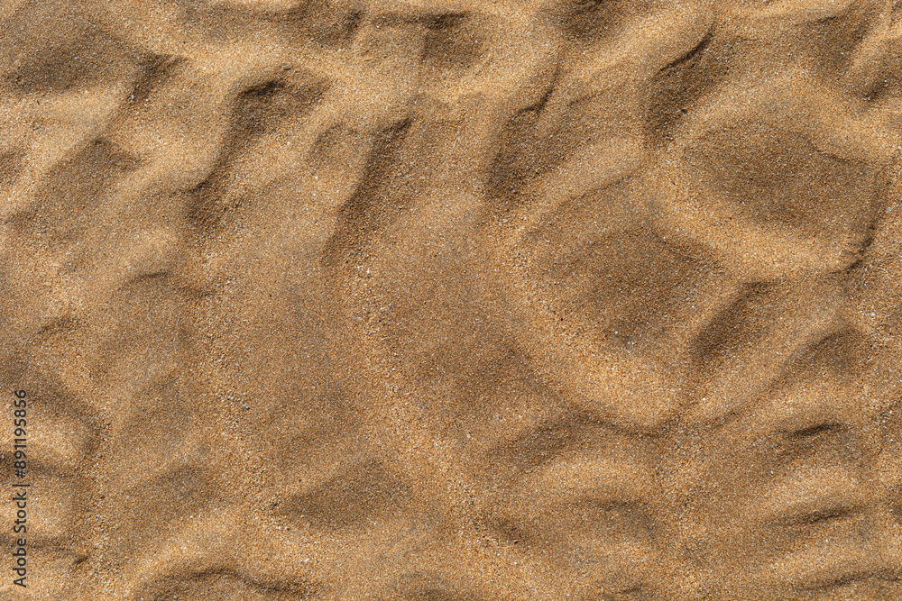 Texture of beach sand washed by the sea with ripple.