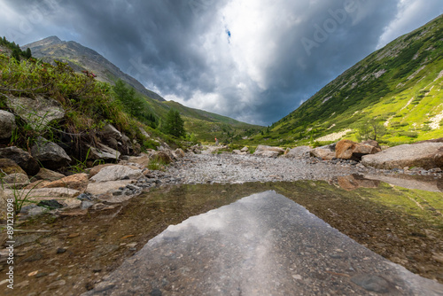 Dramatic Mountain Stream: Stormy Alpine Landscape (Zillertal, AT) photo