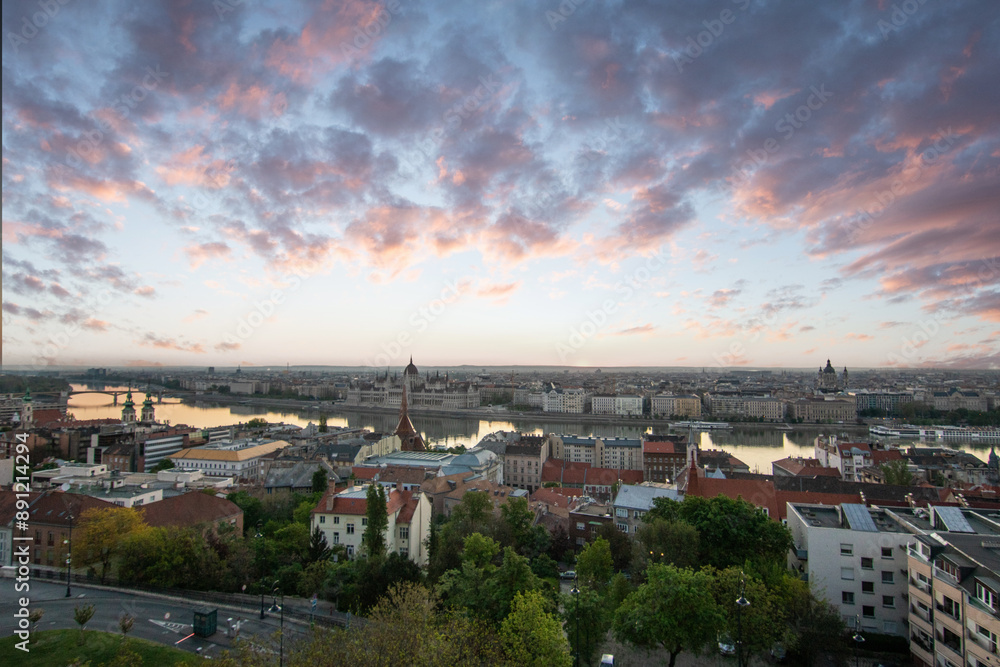 An incredible city view at sunrise or sunset. Extensive city panorama with historical buildings on the Danube. Taken from the mountain side of Buda, the city of Budapest in Hungary An incredible city view at sunrise or sunset. Extensive city panorama with historical buildings on the Danube. Taken from the mountain side of Buda, the city of Budapest in Hungary