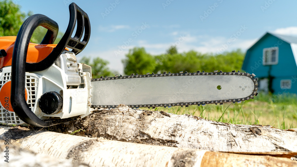 Carpenter or builder with chainsaw in hand Carpenter or builder with chainsaw in hand