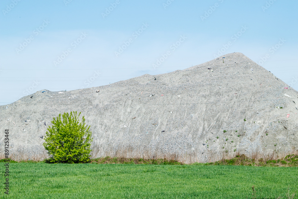 A large pile of rubble for road construction. Crushed stone for concrete mix. large piles of crushed granite or gravel in the concrete industry. A large pile of rubble for road construction. Crushed stone for concrete mix. large piles of crushed granite or gravel in the concrete industry.