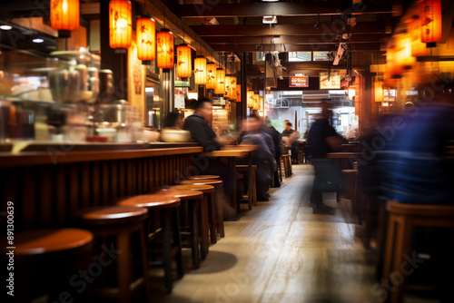 Traditional Japanese Izakaya with customers round chair yellow lanterns in warm bar pub with motion blur light speed effect photograph style