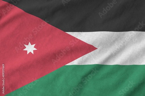 Jordan flag depicted on folded wavy fabric of old cloth close up photo