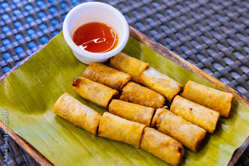 a plate of lumpia, Filipino spring rolls, served on banana leaf