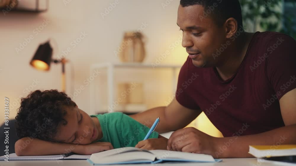 African American dad motivating lazy son to do homework, offering encouragement African American dad motivating lazy son to do homework, offering encouragement