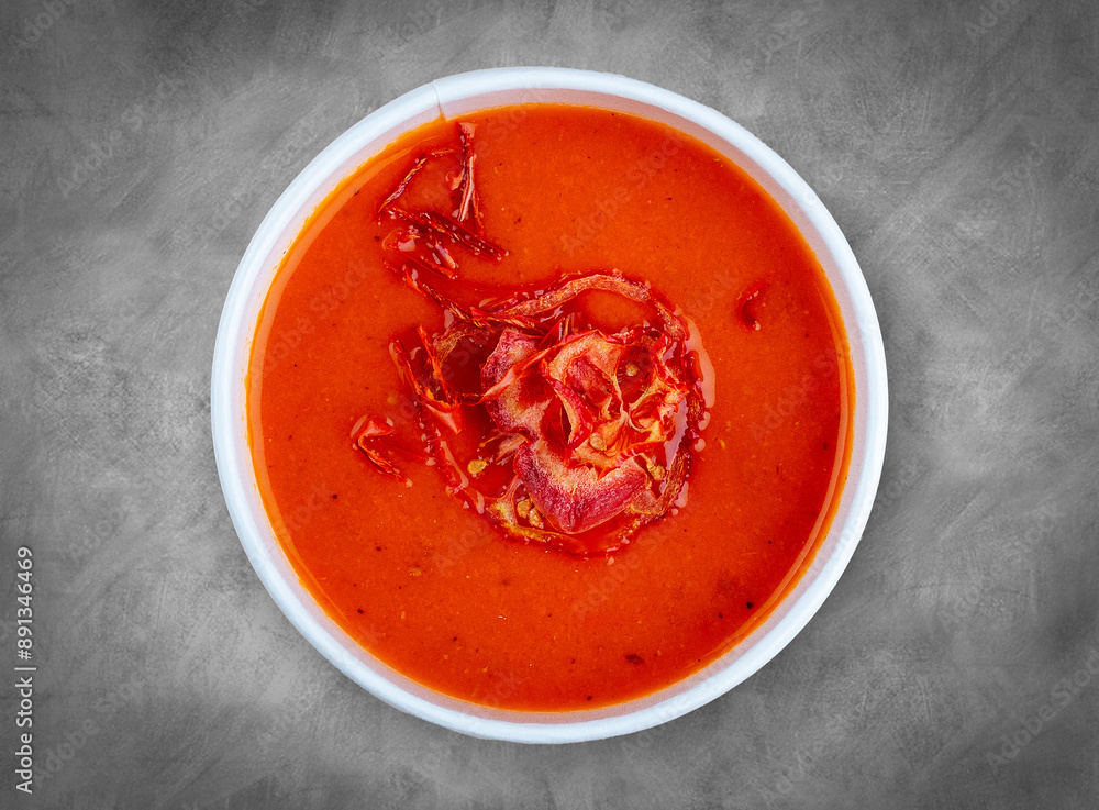 Tomato soup. Healthy food. Takeaway food. Top view, on a gray background. Tomato soup. Healthy food. Takeaway food. Top view, on a gray background.