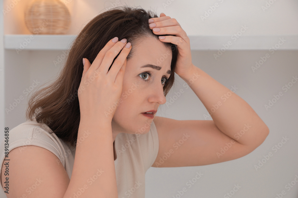 Naklejka premium Woman with hair loss problem at home