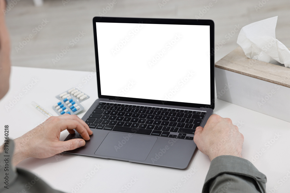 Sick man having online consultation with doctor via laptop at white table indoors, closeup Sick man having online consultation with doctor via laptop at white table indoors, closeup