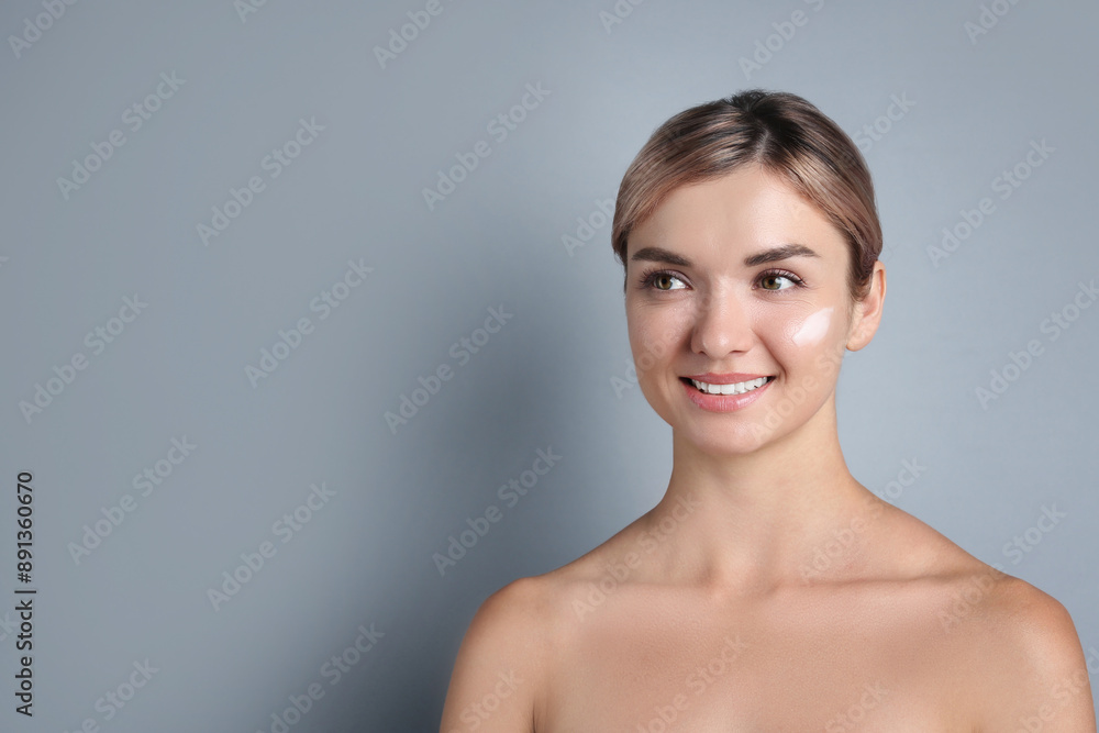 Beautiful woman with cream on her face against gray background, space for text Beautiful woman with cream on her face against gray background, space for text