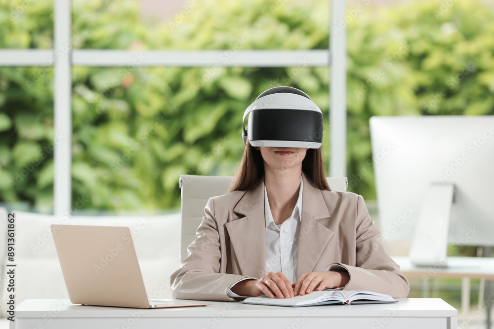 Woman using virtual reality headset in office Woman using virtual reality headset in office