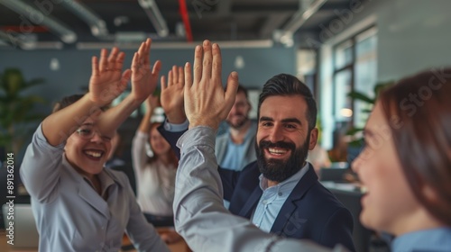 A group of people are high fiving each other in a business setting