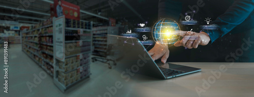 A person is using a laptop in a store. The laptop is displaying a globe and a person is touching it