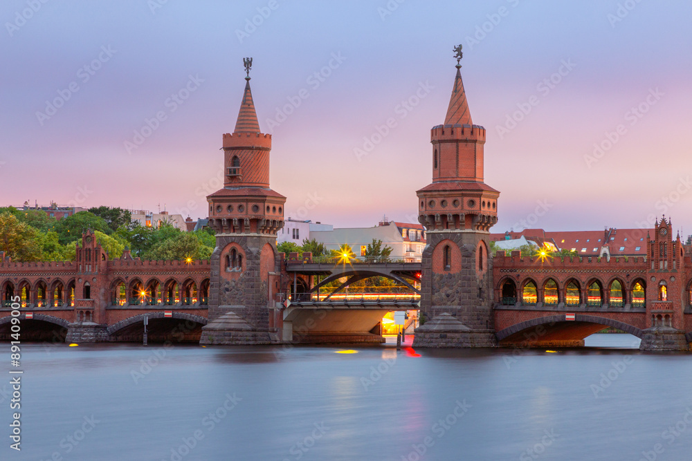 Fototapeta premium Old Berlin Oberbaum Bridge over the Spree River at sunset.