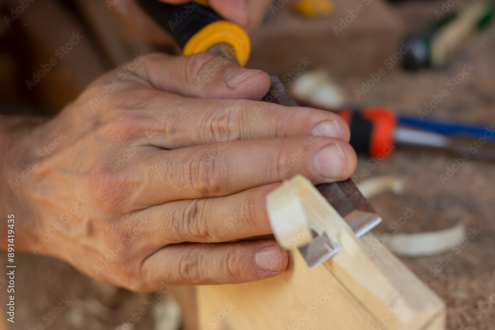 close up of hands working on a wooden board (cutting) close up of hands working on a wooden board (cutting)