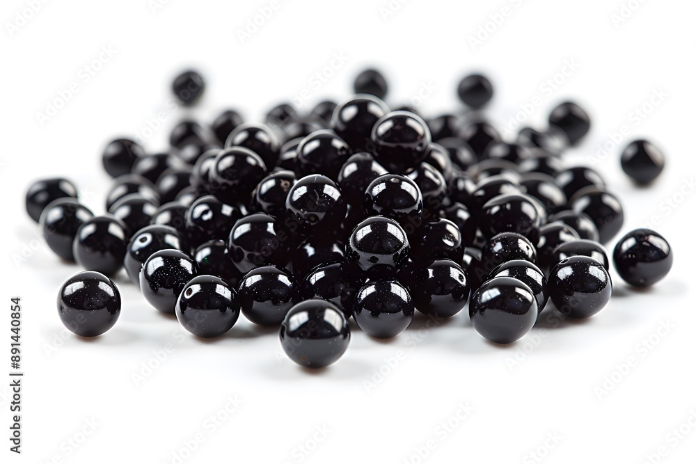 A Glimmering Pile of Black Beads on a White Background A Glimmering Pile of Black Beads on a White Background