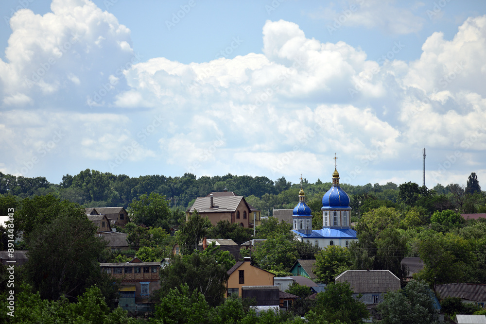 church. view of the Ukrainian church in the village. religion, Christianity. church holidays. crosses on the domes. no people. roofs of houses. summer time. Orthodox church. church. view of the Ukrainian church in the village. religion, Christianity. church holidays. crosses on the domes. no people. roofs of houses. summer time. Orthodox church.