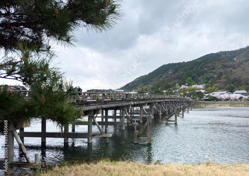 Wooden old Uji Bridge over river. Kyoto Japan.