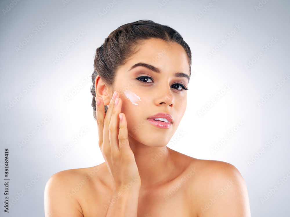 Skincare, portrait and woman in studio with balm, cosmetics and make up foundation. Dermatology, female person and facial care on gray background with moisturizer, cream and treatment for soft skin Skincare, portrait and woman in studio with balm, cosmetics and make up foundation. Dermatology, female person and facial care on gray background with moisturizer, cream and treatment for soft skin