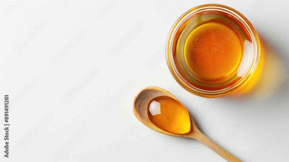 Honey in glass jar with wooden spoon isolated on white background Honey in glass jar with wooden spoon isolated on white background