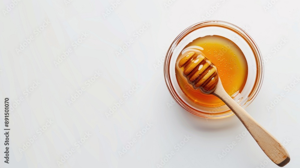 Honey in glass jar with wooden spoon isolated on white background Honey in glass jar with wooden spoon isolated on white background