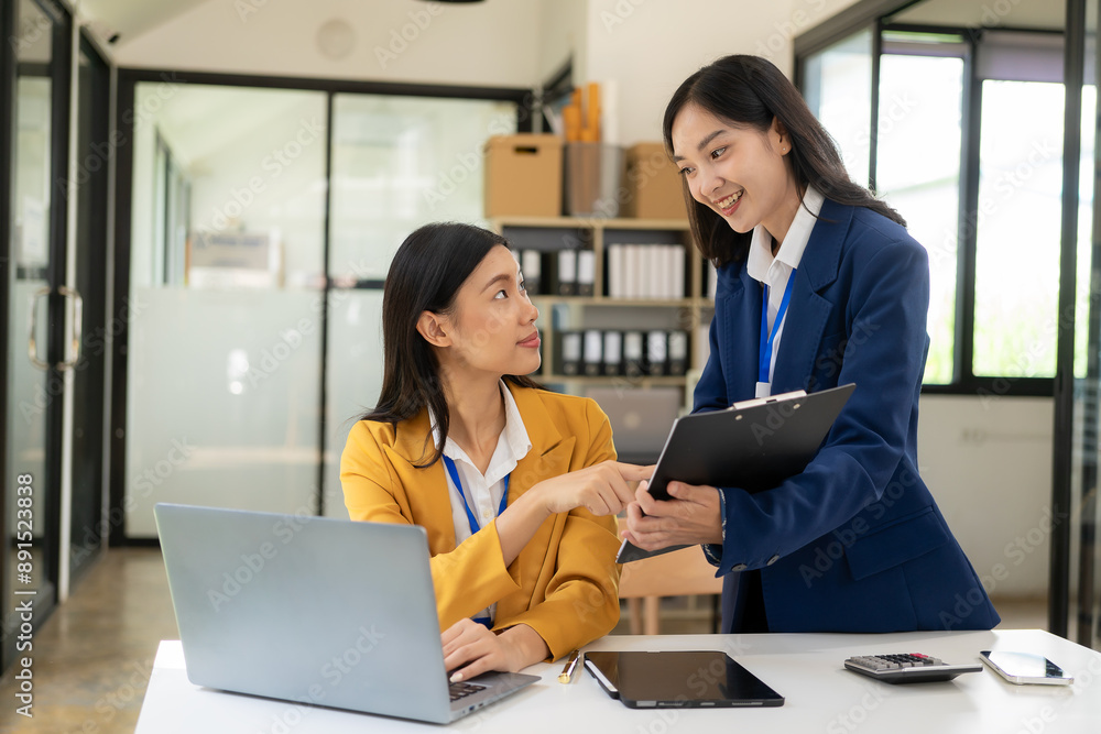 Two Asian businesswomen discuss pitching a new startup project idea. Analysis, planning and financial statistics, company business collaboration concept. Two Asian businesswomen discuss pitching a new startup project idea. Analysis, planning and financial statistics, company business collaboration concept.