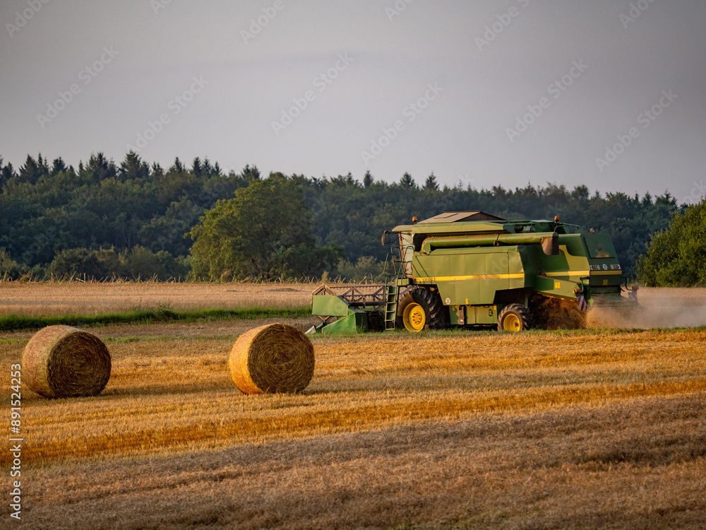 Fototapeta premium Mähdrescher bei der Arbeit im Feld
