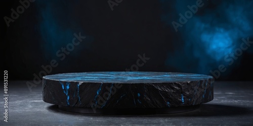 black stone platform podium with blue color light on black background for product display presentation and advertising copy space.