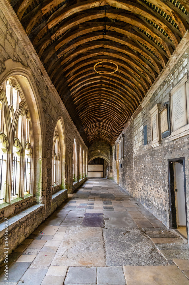 A view along a colonnade in Chichester Cathedral in the center of Chichester, Sussex in summertime A view along a colonnade in Chichester Cathedral in the center of Chichester, Sussex in summertime