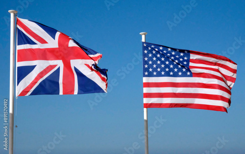 Stars and Stripes and Union Jack - US and UK national flags against the blue sky