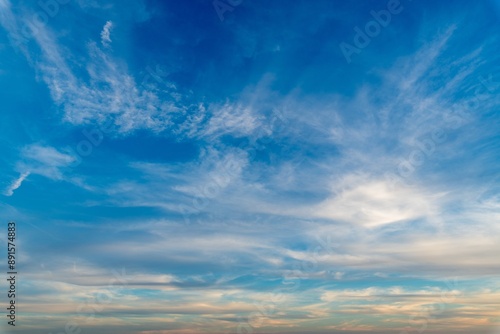 Low angle shot of white clouds in a clear blue sky