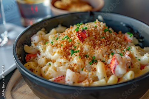 A bowl of lobster mac and cheese, creamy and cheesy, with chunks of lobster meat and a crispy breadcrumb topping