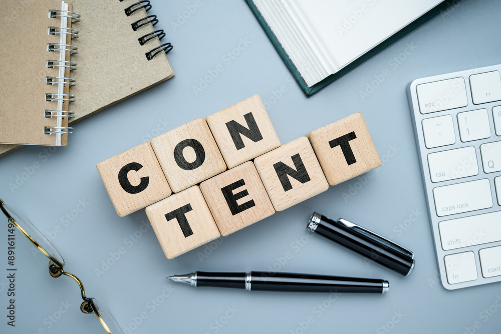 CONTENT word by alphabet wood blocks with part of writing tools on the table, creating content concept CONTENT word by alphabet wood blocks with part of writing tools on the table, creating content concept