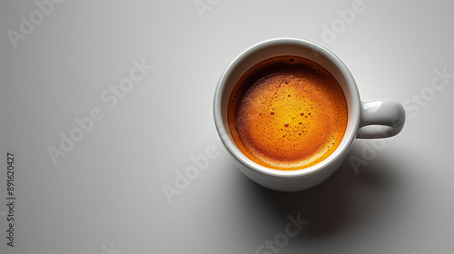 A minimalist clipart image featuring a white cup of coffee viewed from above on a plain gray background. The coffee has a rich, dark brown color with visible crema.