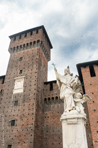 Bona tower and San Giovanni Nepomuceno monument in Sforzesco Castle on a cloudy summer day. Milan, Italy.  photo