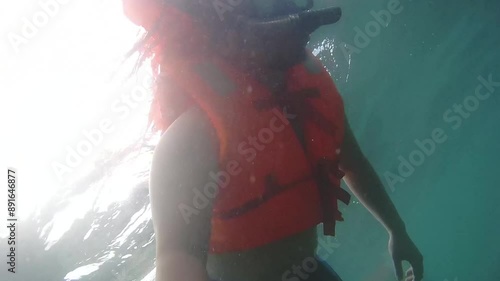 Person Snorkeling in Clear Water with Life Jacket at Labuan Bajo photo