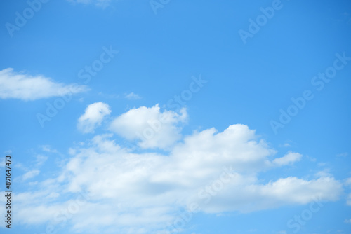Fototapeta Naklejka Na Ścianę i Meble -  small white cumulus clouds float in the blue sky