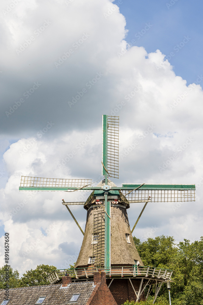 Floor windmill in the center of village Norg in Municipality Noordenveld in the Netherlands. Traditional Esdorp in Northern Drenthe. Floor windmill in the center of village Norg in Municipality Noordenveld in the Netherlands. Traditional Esdorp in Northern Drenthe.