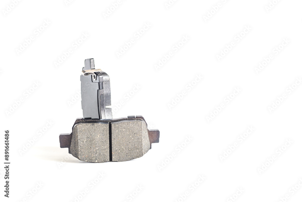 Two brake pads for a car in close-up on a light background, isolate Two brake pads for a car in close-up on a light background, isolate