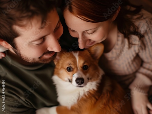 Couple Cuddles Their Corgi Dog at Home