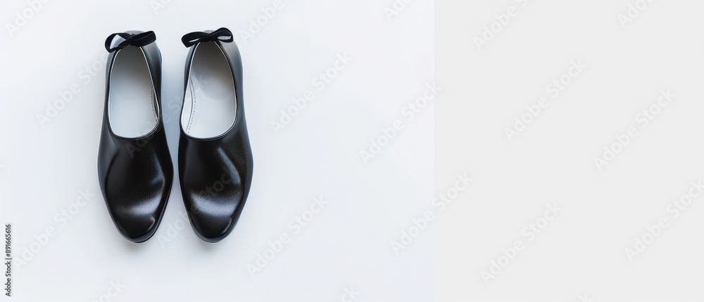 A pair of black shoes with a white sole A pair of black shoes with a white sole