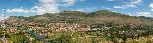 Trebinje town panorama view from height with river, mountains and tile roofs at background photo