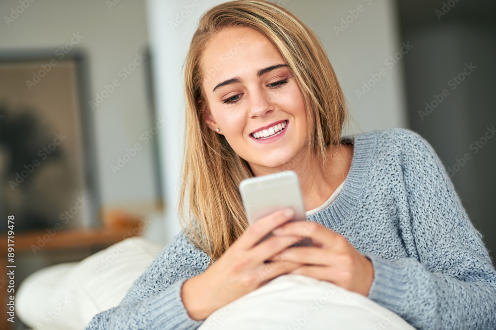 Woman, home and relaxing on sofa with smartphone for social media, online post and watch videos for fun. Girl, couch and smile or laugh in lounge for entertainment, streaming service and website Woman, home and relaxing on sofa with smartphone for social media, online post and watch videos for fun. Girl, couch and smile or laugh in lounge for entertainment, streaming service and website