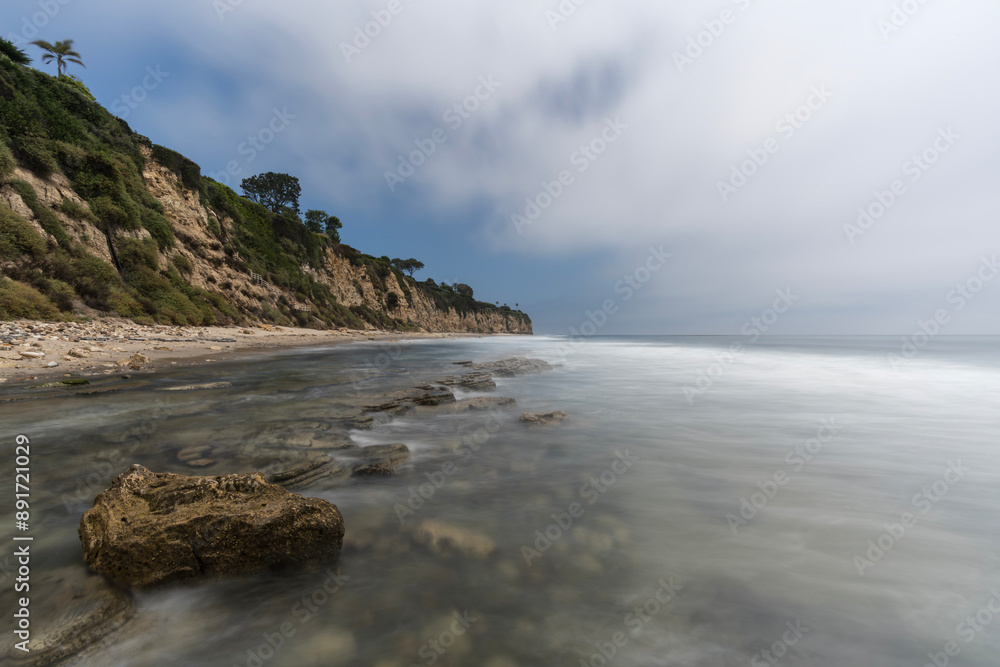 Secluded Dume Cove beach with clearing fog and motion blur water in Malibu, California. Secluded Dume Cove beach with clearing fog and motion blur water in Malibu, California.