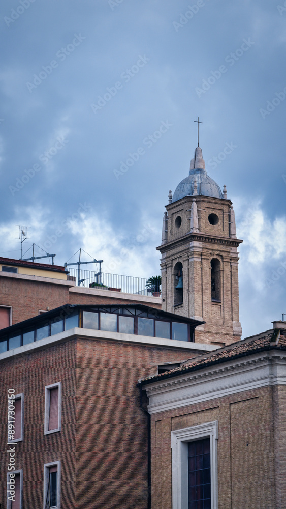 A view across the rooftops of Rome at sunset on a winter day. Domes of old church A view across the rooftops of Rome at sunset on a winter day. Domes of old church
