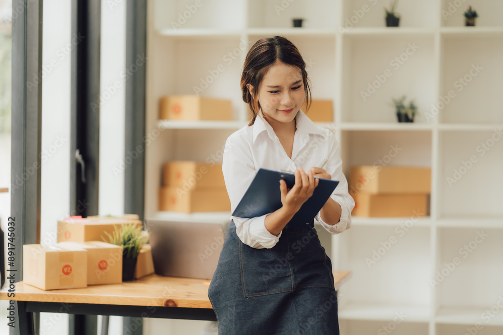 Small business entrepreneur SME freelance woman working at office, BOX,tablet and laptop online, marketing, packaging, delivery, e-commerce concept Small business entrepreneur SME freelance woman working at office, BOX,tablet and laptop online, marketing, packaging, delivery, e-commerce concept