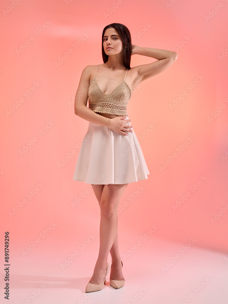 a beautiful woman in a knitted summer top poses on a monochrome colored background smiling happily a beautiful woman in a knitted summer top poses on a monochrome colored background smiling happily